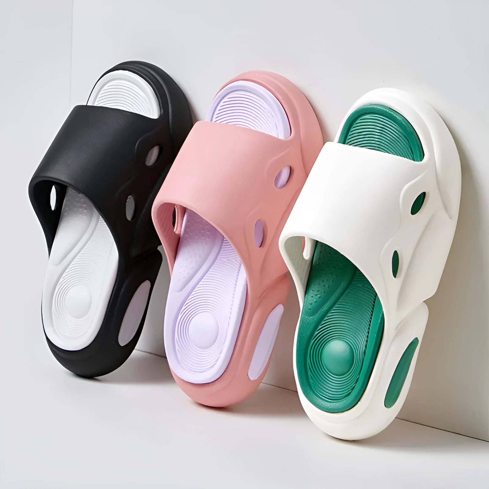 Two-colour EVA couples slippers with thick sole and leather lining in pink purple, shown from the side.