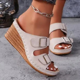 Women's creamy-white wedge beach slippers with buckle strap closure on rubber sole