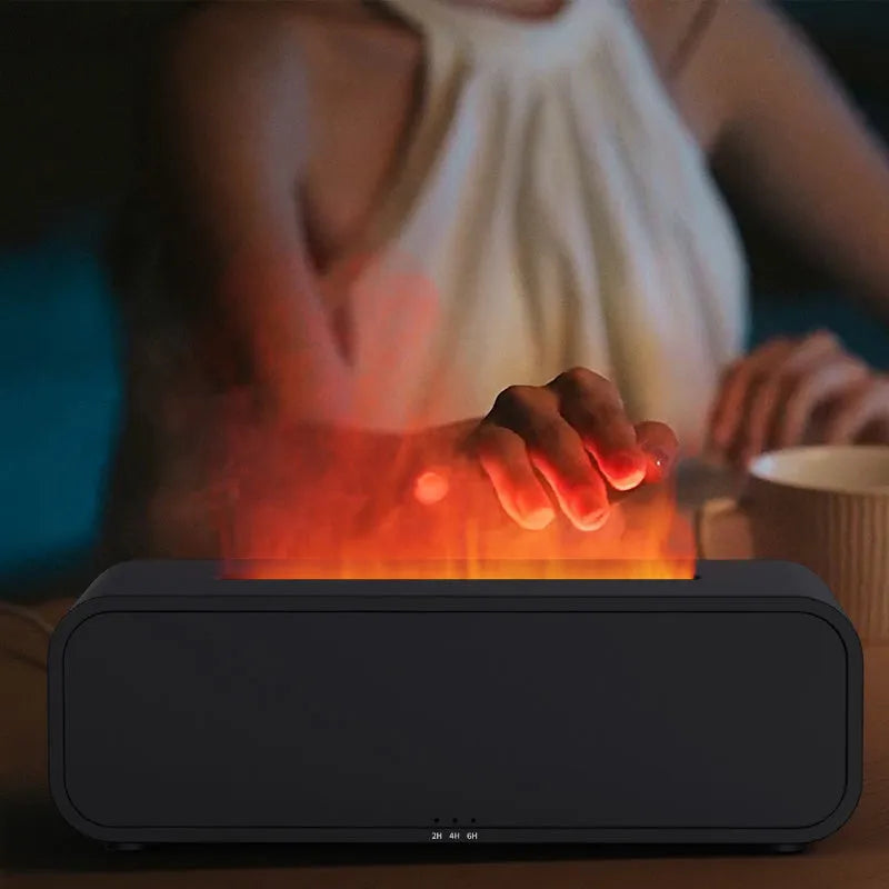 Black and white USB aroma diffuser with remote control on a desk, showing colour-changing LED lights.
