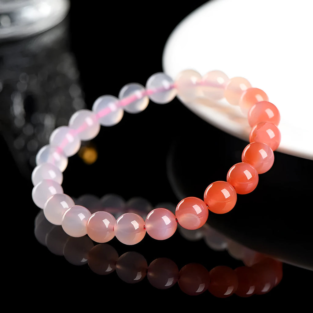 Natural gradient Yanyuan agate bracelet with geometric beads in salt source colour on a white background