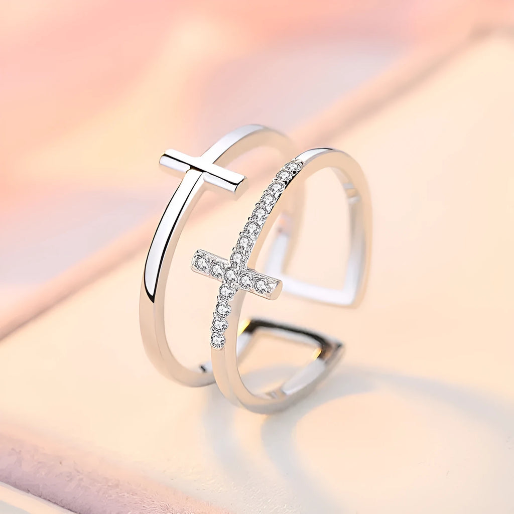 Adjustable double cross geometric ring made of copper with white gold finish and inlaid zircon stones.