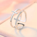 Adjustable double cross geometric ring made of copper with white gold finish and inlaid zircon stones.