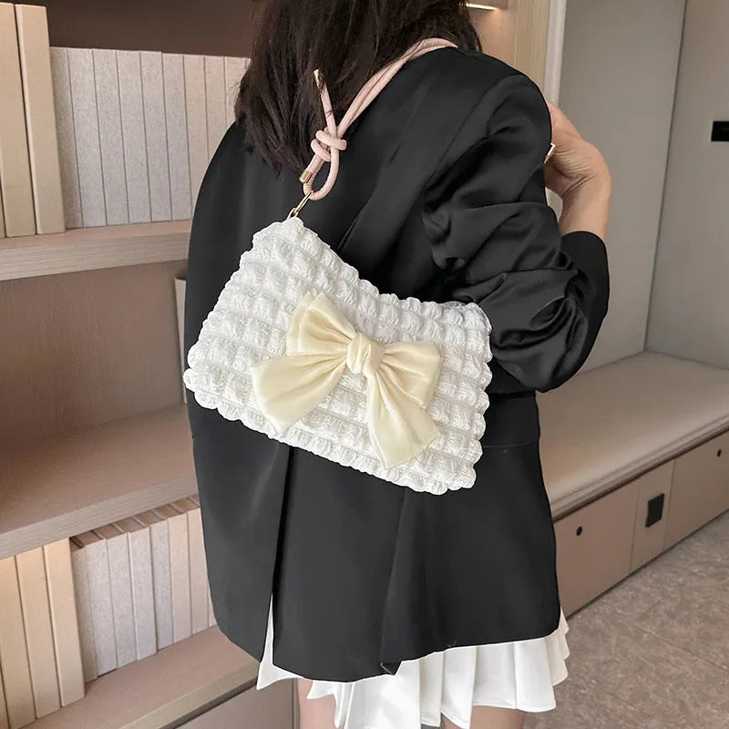 Women's black canvas crossbody handbag with single shoulder strap and outer sandwich pocket.