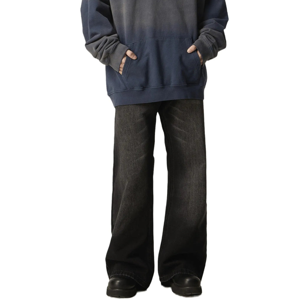 Black loose straight-leg retro jeans on a hanger, showing the front view with zipper fly.