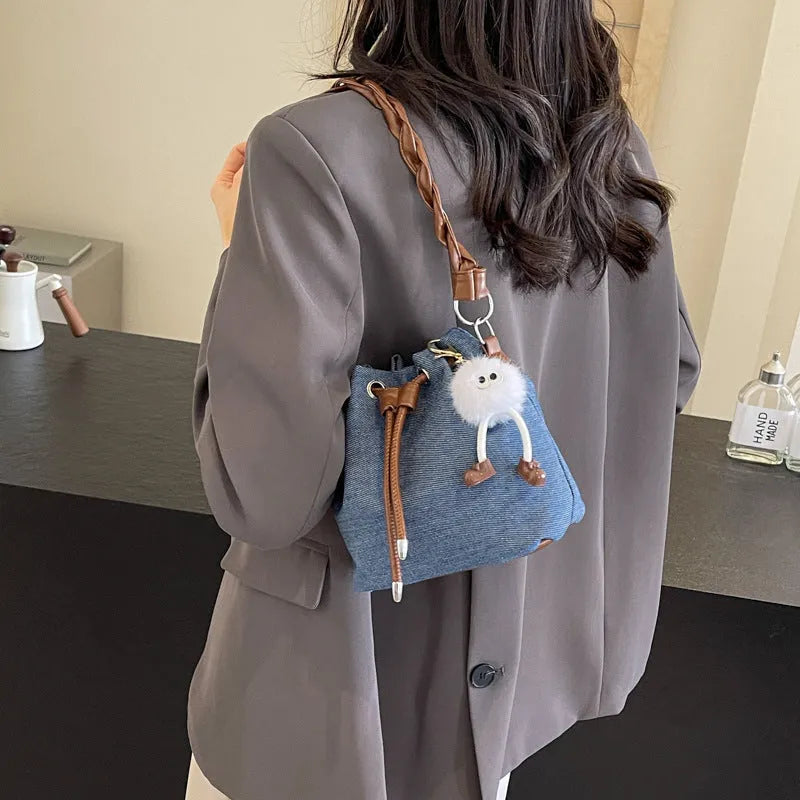Blue cross body bucket messenger bag with synthetic leather construction