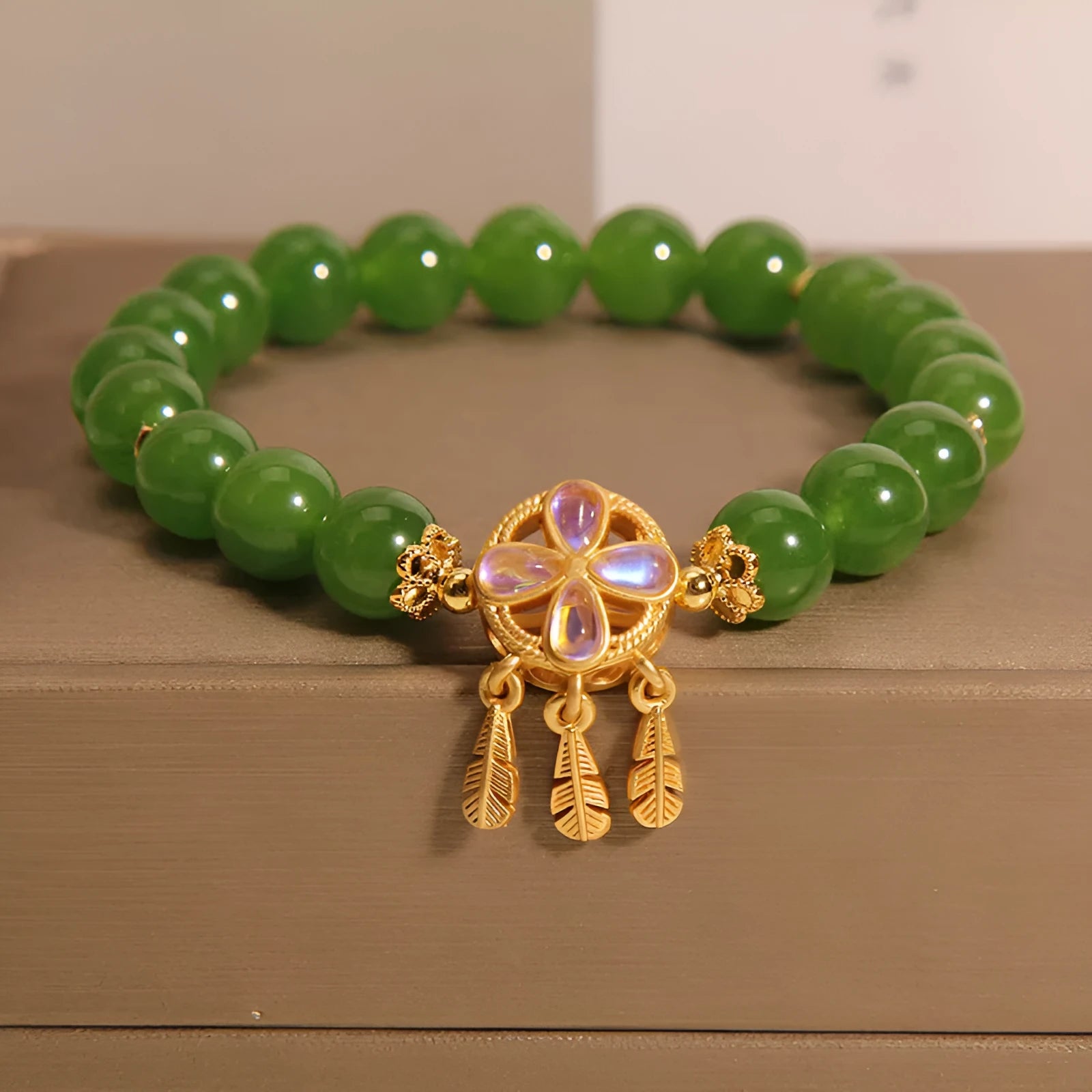 Green jasper bracelet for women with a crystal four-leaf clover dream catcher pendant.