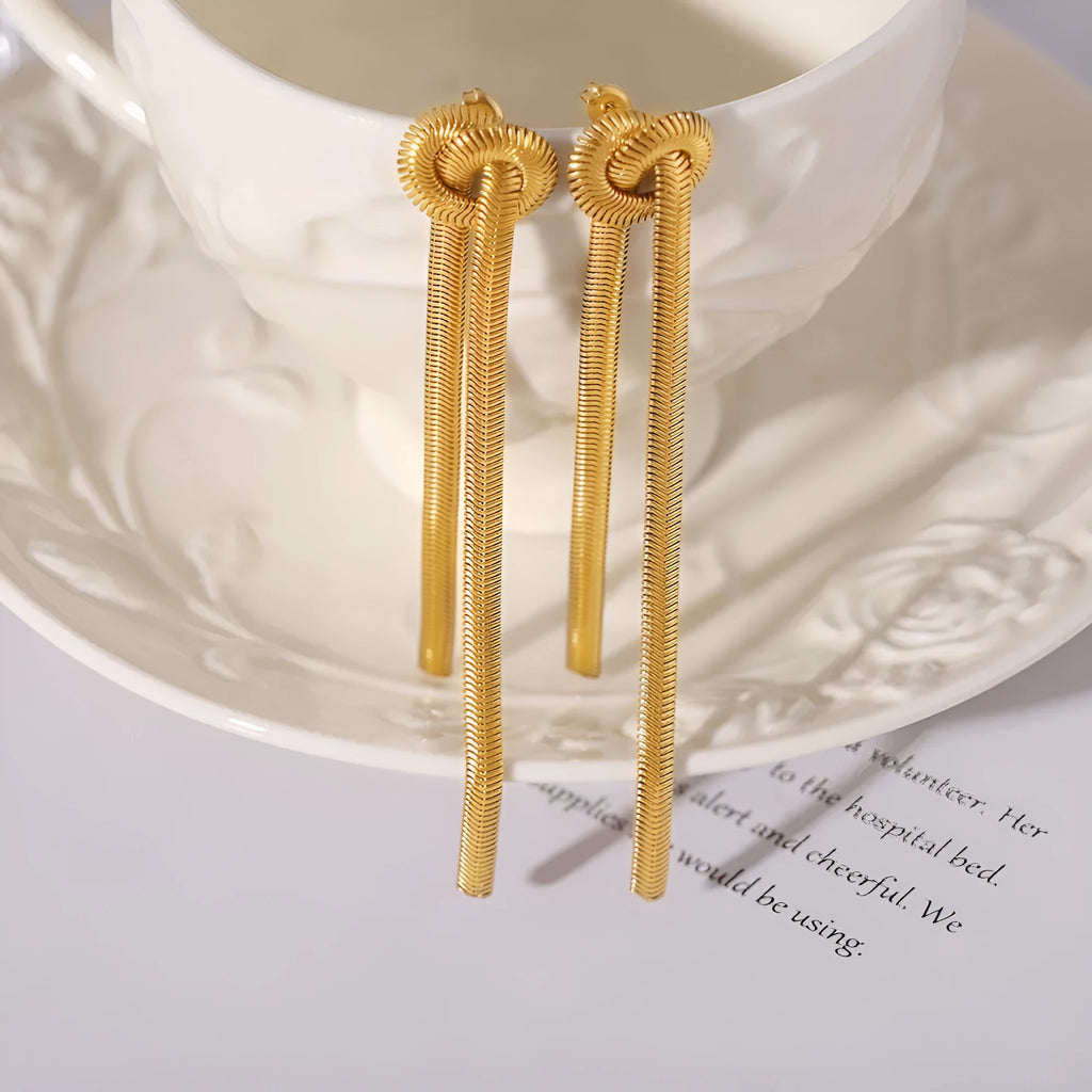 Gold colour knotted tassel pendant on a snake chain necklace with matching electroplated earrings.
