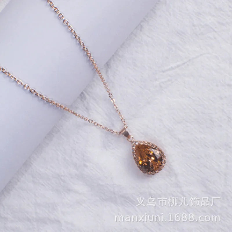 Rose gold water drop shape necklace with rhinestone geometric detailing in pink colour