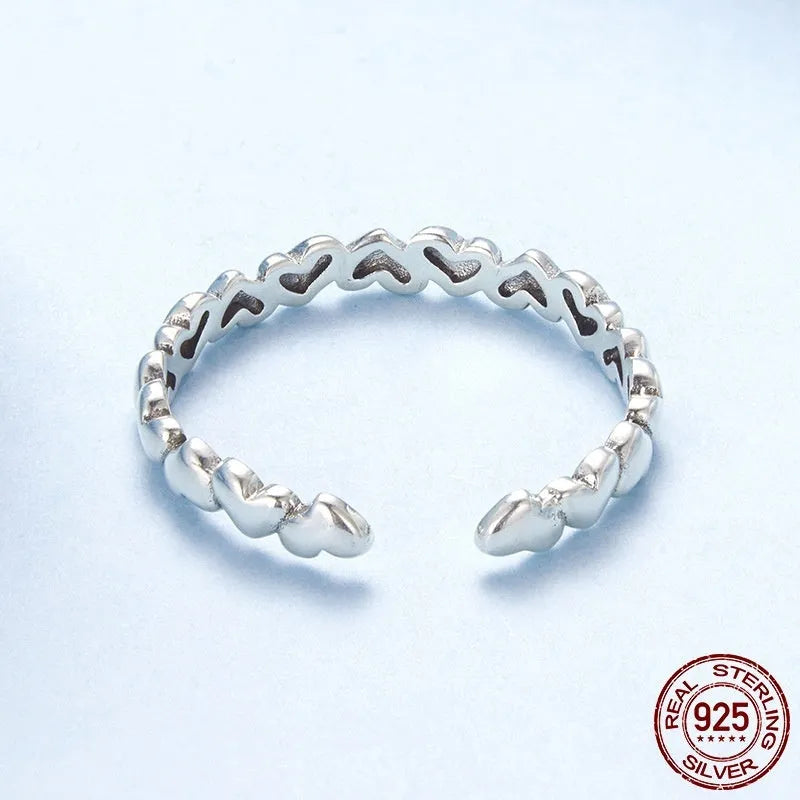 925 sterling silver open heart ring on white background with adjustable band and polished finish