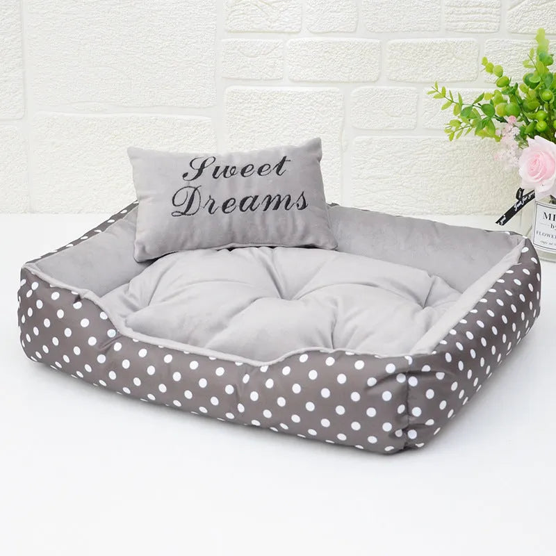 Polka dot printed square dog bed with a matching embroidery pillow in rose red, shown in a small size.