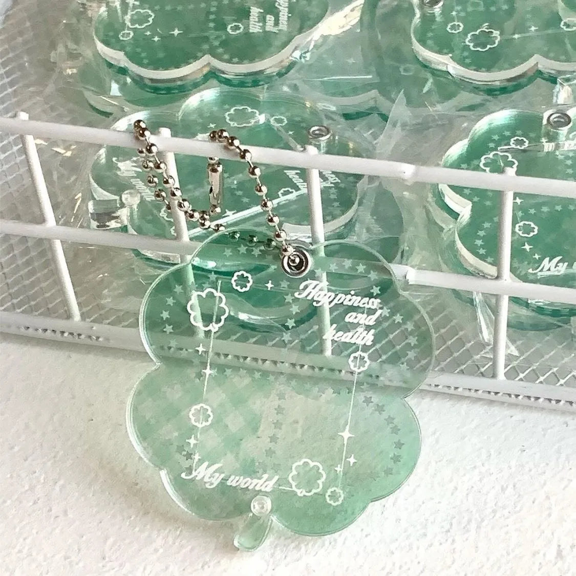 Acrylic four-leaf clover shape keychain pendant for phones in blue, green, or mint.