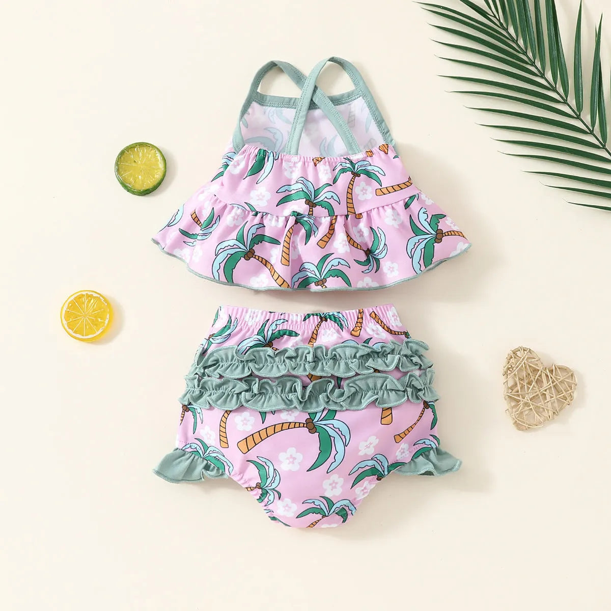 White sweet style girls' two-piece swimsuit set with shirt top and beach shorts on a hanger.