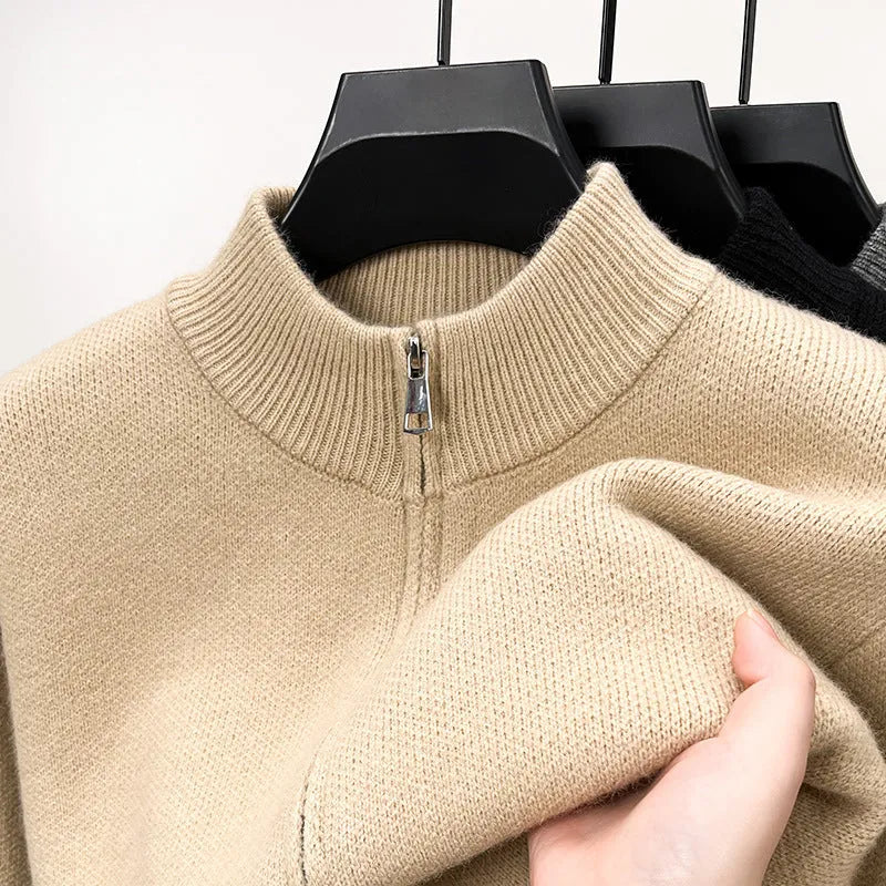 Men's black zip-up knitted cardigan with a stand collar on a hanger