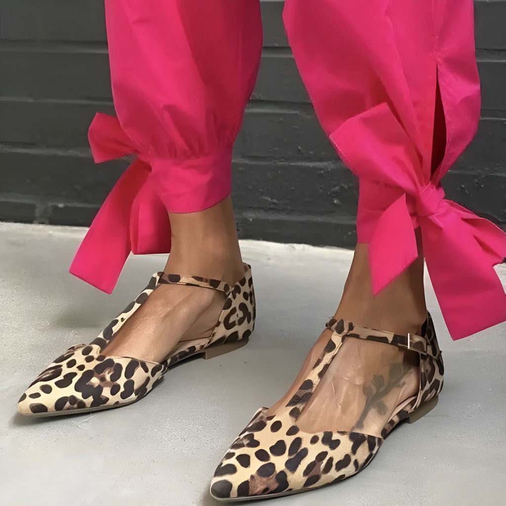 Leopard print women's pumps with cross shoulder straps and a chunky low heel