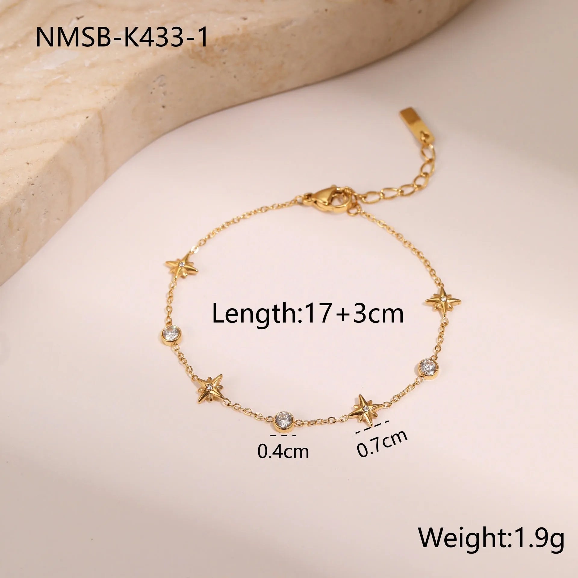 Women's stainless steel bracelet with 18K gold plating and a geometric zircon star pendant on wrist.