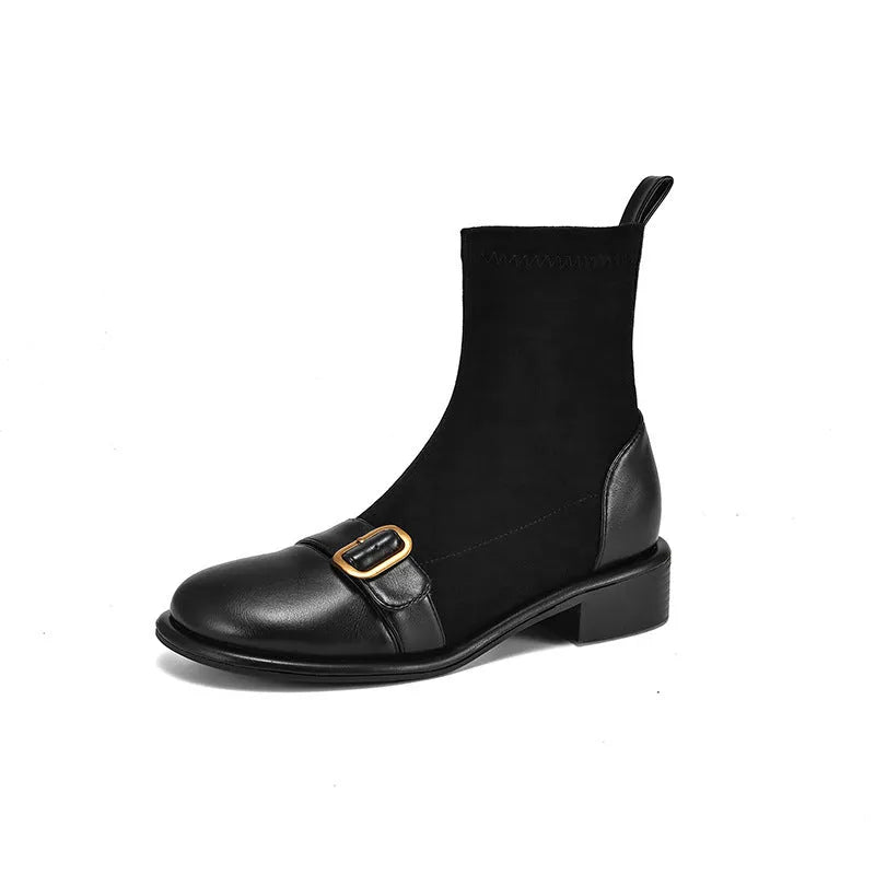 Women's black low heel Martin boots with belt buckle stitching and front lace-up closure on a round toe.