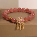 Women's strawberry quartz bracelet with four leaf dream catcher ball pendant