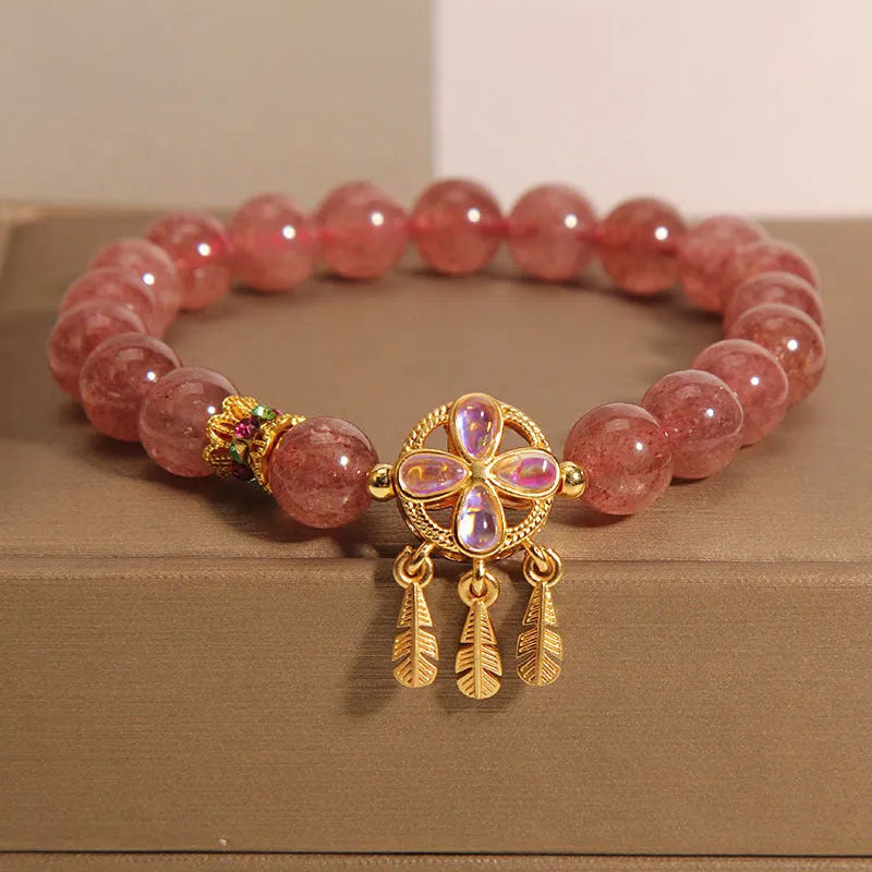 Women's strawberry quartz bracelet with four leaf dream catcher ball pendant