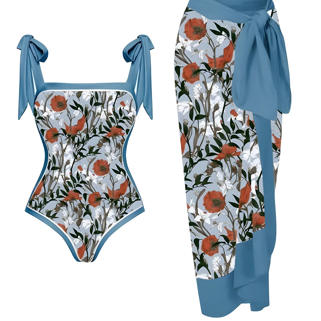 Women's floral print two-piece swimsuit with a blue chiffon skirt laid flat.