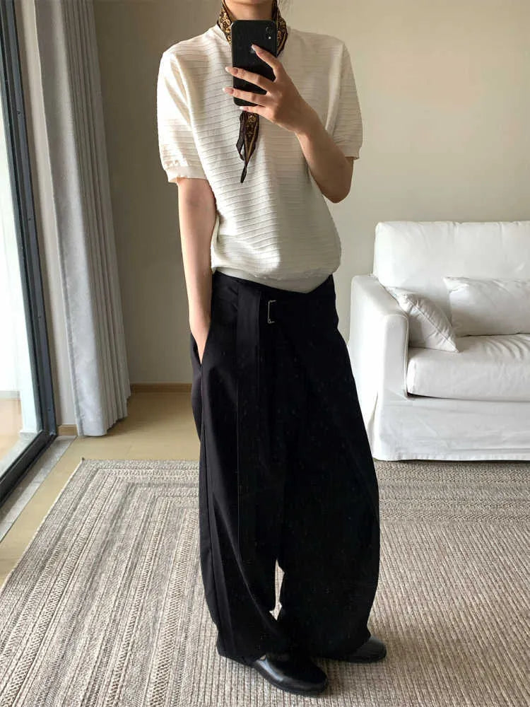 Black straight-leg trousers with a single front pleat and adjustable waistband, laid flat.