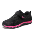 Women's low-top wedge heel shoes with mesh upper and Velcro strap in a solid colour.