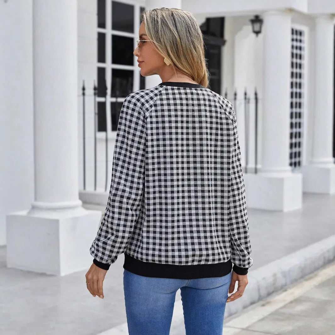 Black long sleeve pullover sweater with printed plaid and stripe pattern.