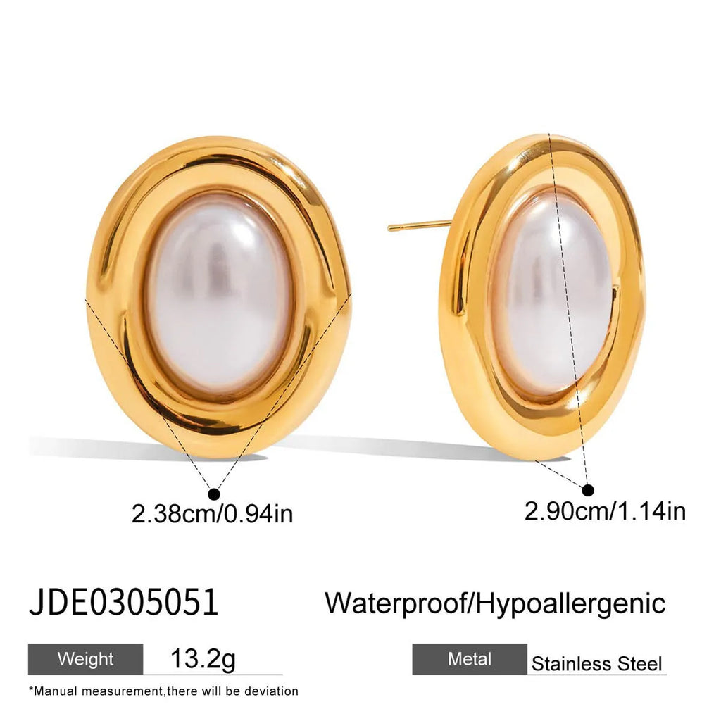 A pair of silver-colour stainless steel stud earrings with a small white pearl detail on a grey background.