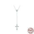 Close-up of a delicate silver love cross pendant on a thin O-ring chain, designed for V-neck wear.