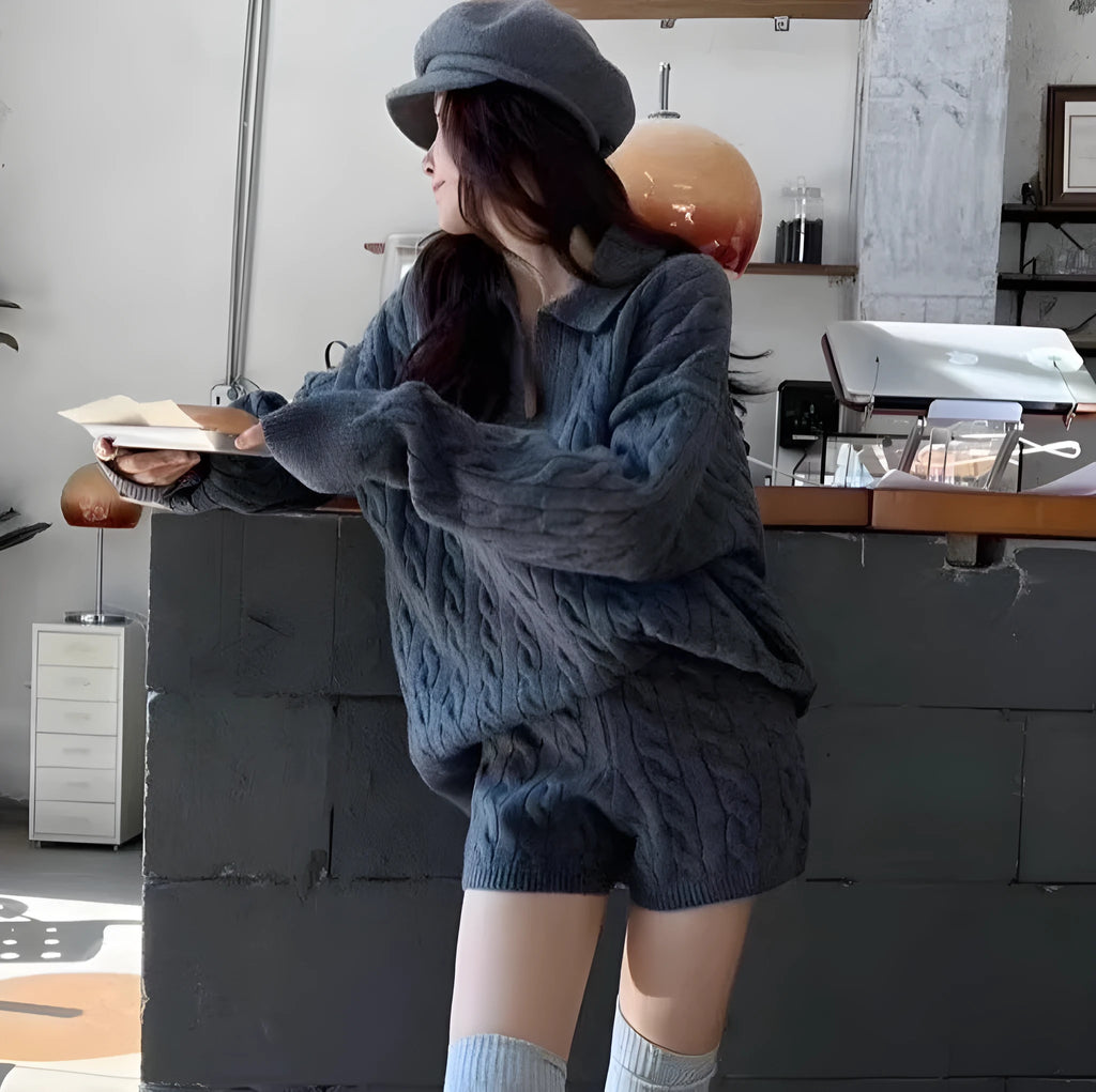 Women's knitted suit set showing cable knit geometric pattern on long sleeve sweater and matching elastic waist shorts
