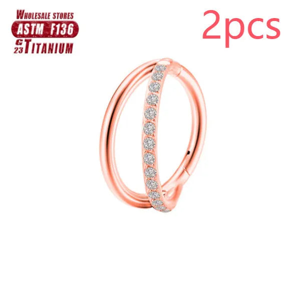 Titanium alloy nose ring on a plain background, shown in silver and gold finishes.