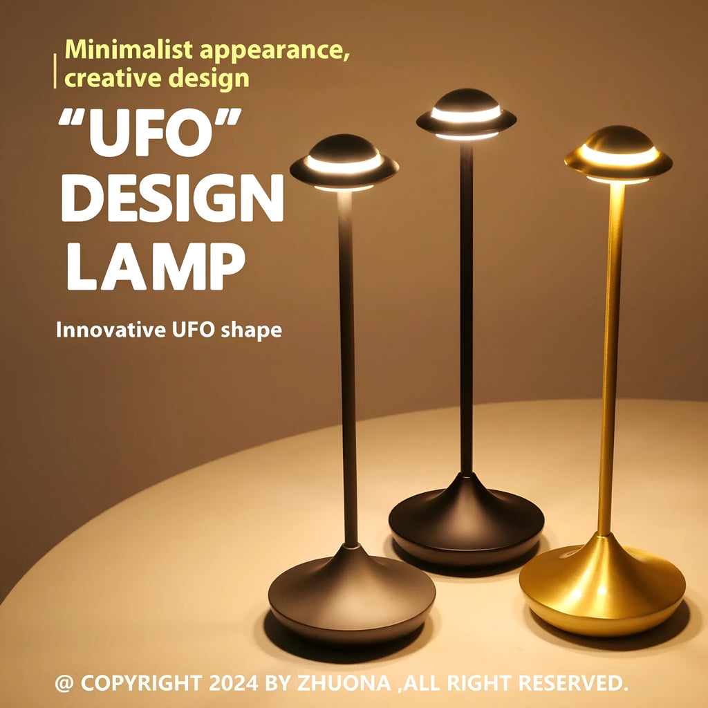 Metallic UFO-shaped desk lamp with touch controls in black finish on wooden surface