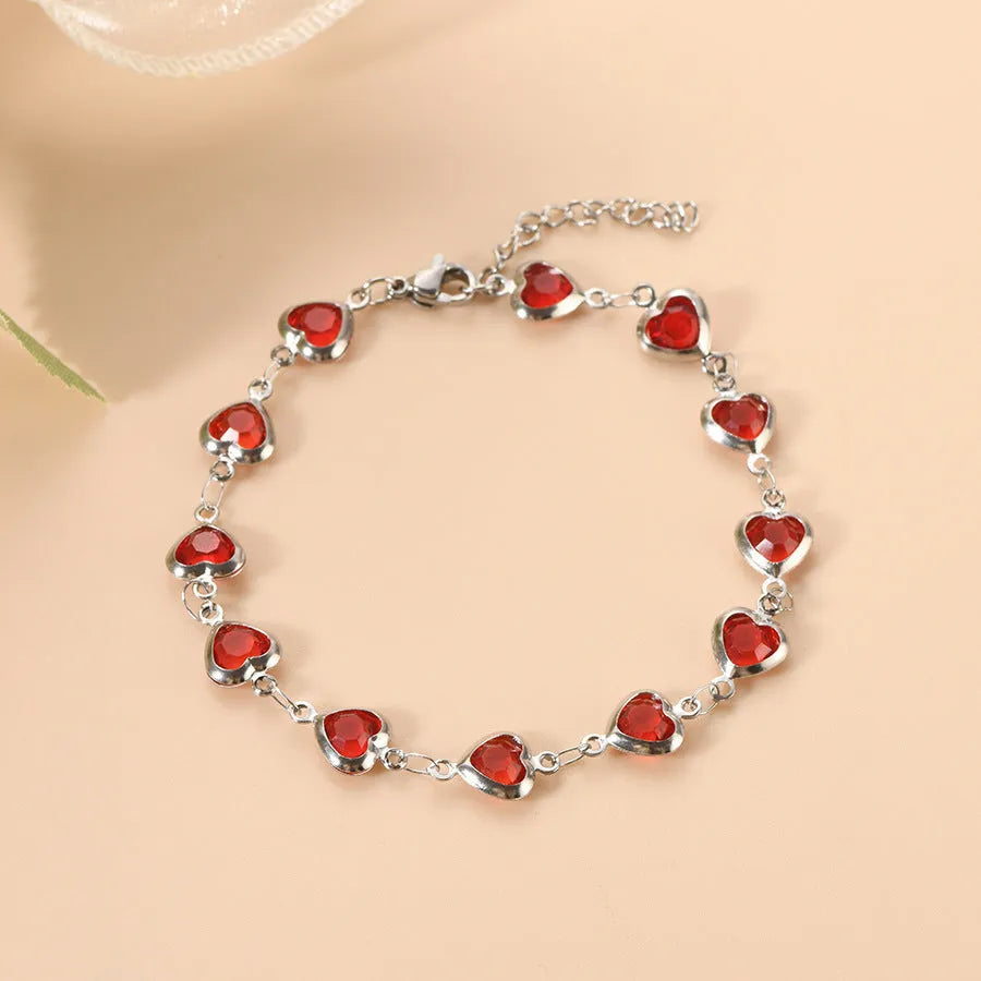 Devil's Eye geometric heart bracelet in stainless steel, shown in colourful, blue, green, and red finishes.