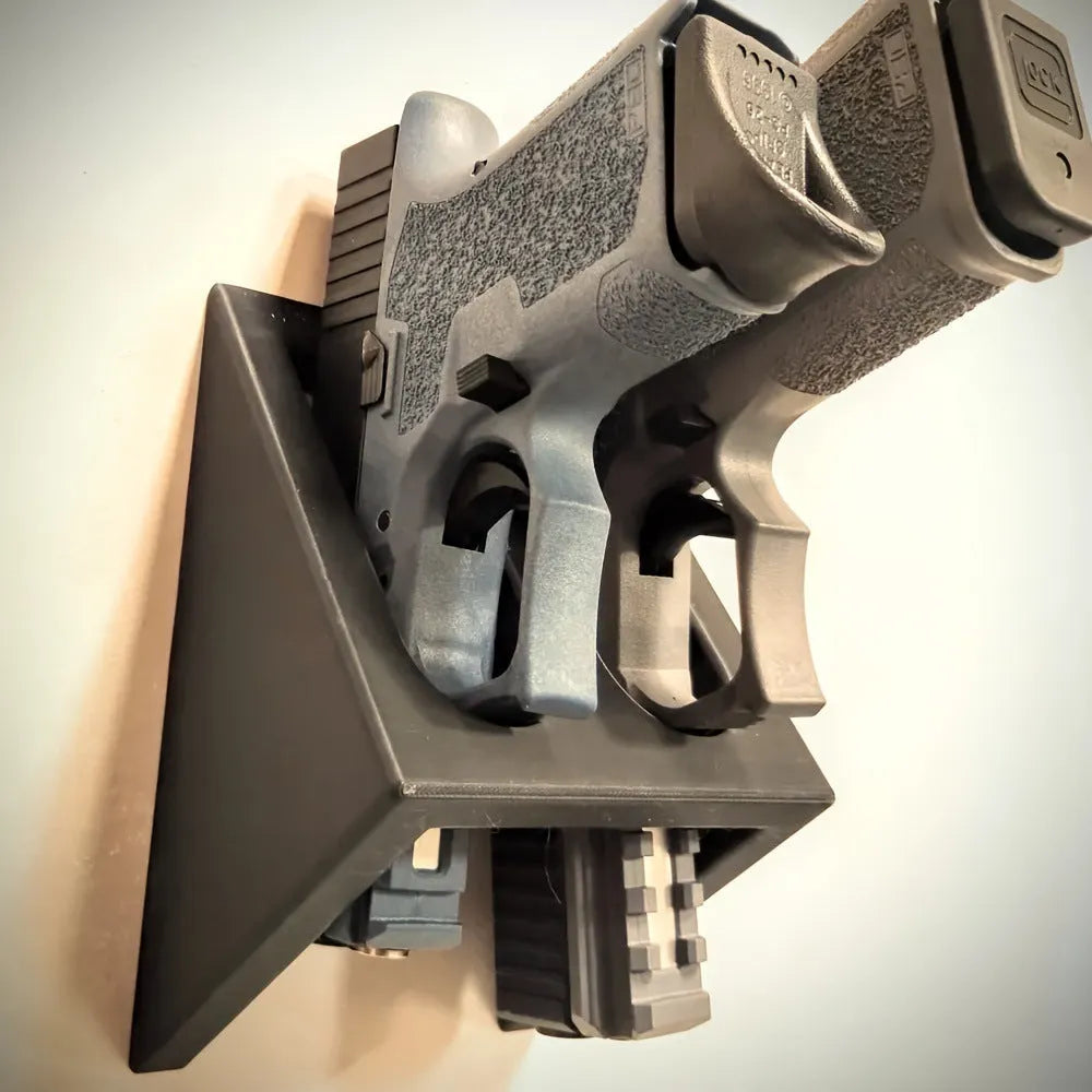 Black plastic pistol display stand with punk-style moulding for 1:1 scale gun models.