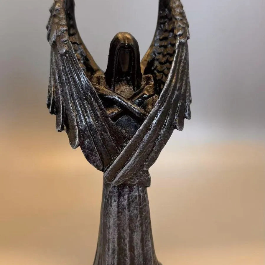 Dark angel resin statue ornament on a shelf, showing detailed sculptural form and dark colour finish.