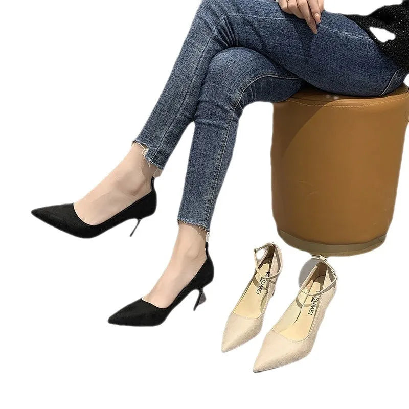 Women's black buckle stiletto pump heel shoe with 8cm heel and rubber sole.