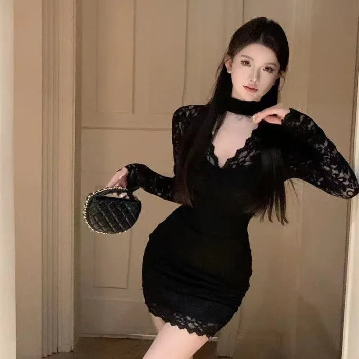 Women's black halter neck lace dress with floral pattern and A-line short skirt.