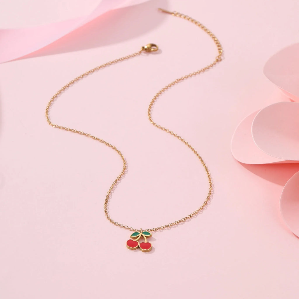 Cherry jewellery set showing necklace, bracelet, earrings, and ring in stainless steel with 18K electroplated finish