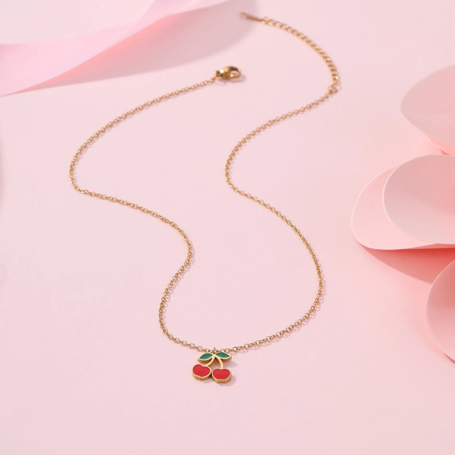Cherry jewellery set showing necklace, bracelet, earrings, and ring in stainless steel with 18K electroplated finish