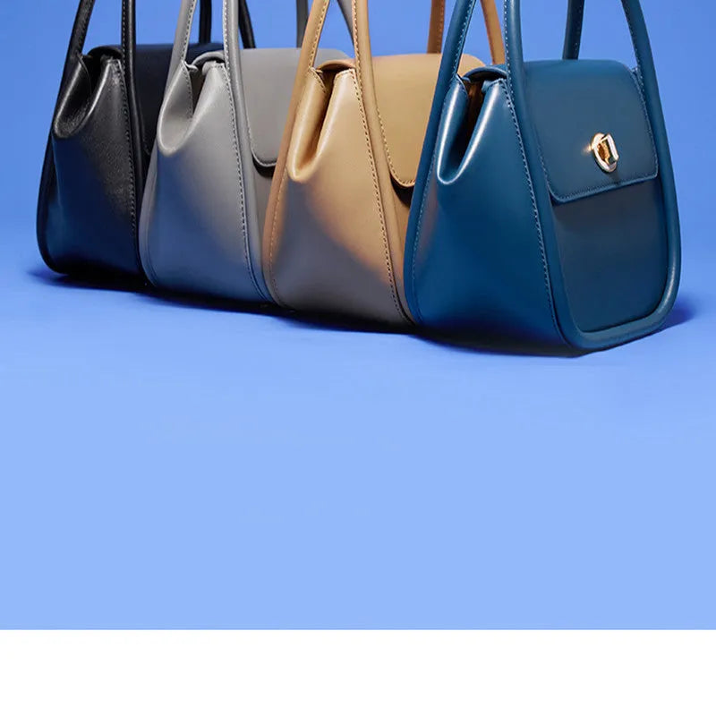 Leather wing bag with latch closure and buckle detailing in cow leather with cross-body strap