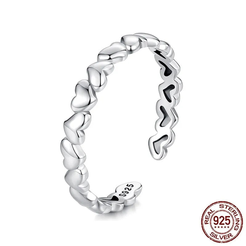 925 sterling silver open heart ring on white background with adjustable band and polished finish