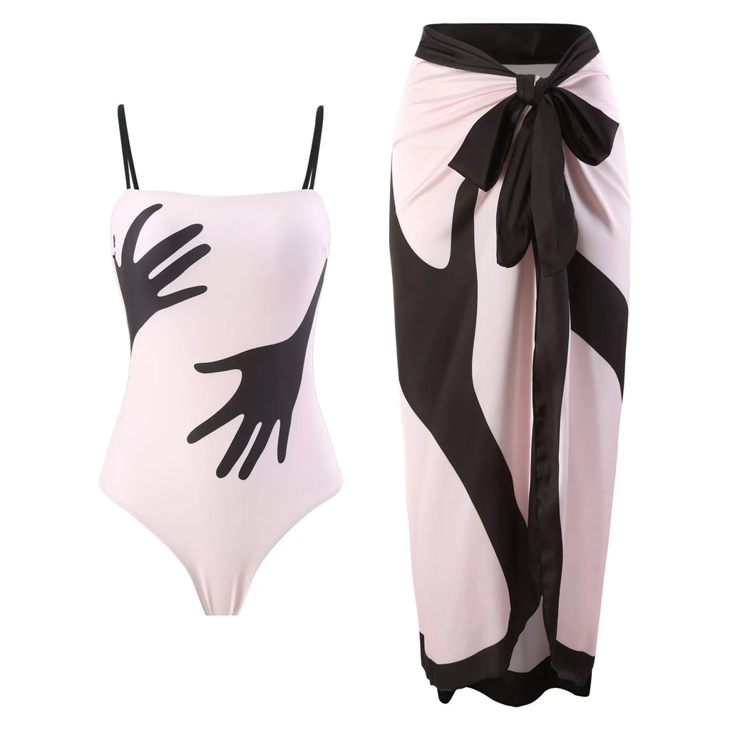 Women's patterned bikini top and bottoms with a matching light blue tulle skirt laid flat.