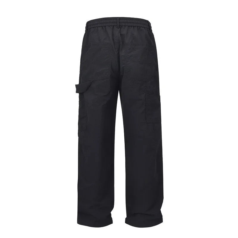 Black paratrooper trousers with elastic drawstring waist and three-dimensional cutting in baggy style
