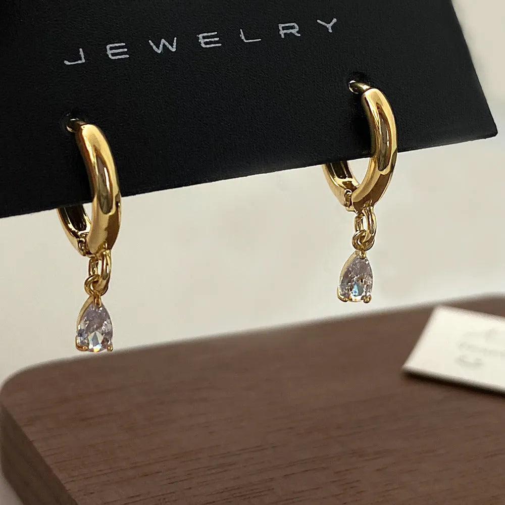 Women's zircon jewellery set showing geometric pendant necklace, matching earrings, and anklet with meteor shower design