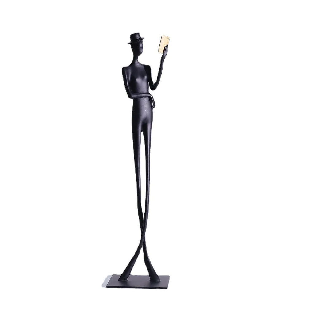 Tall black cast aluminium minimalist character sculpture on a desk, measuring 51cm in height.