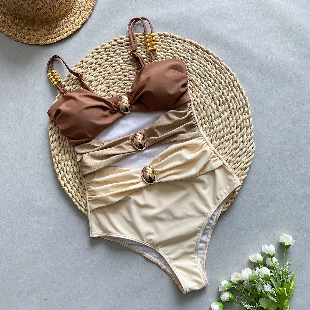 Women's brown one-piece swimsuit with matching beige skirt cover-up on size mannequin