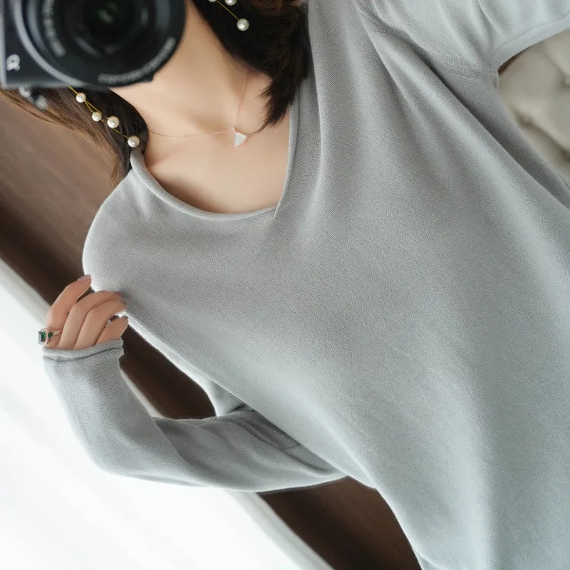 Women's V-neck long sleeve knitwear pullover top in a macaron colour on a hanger.