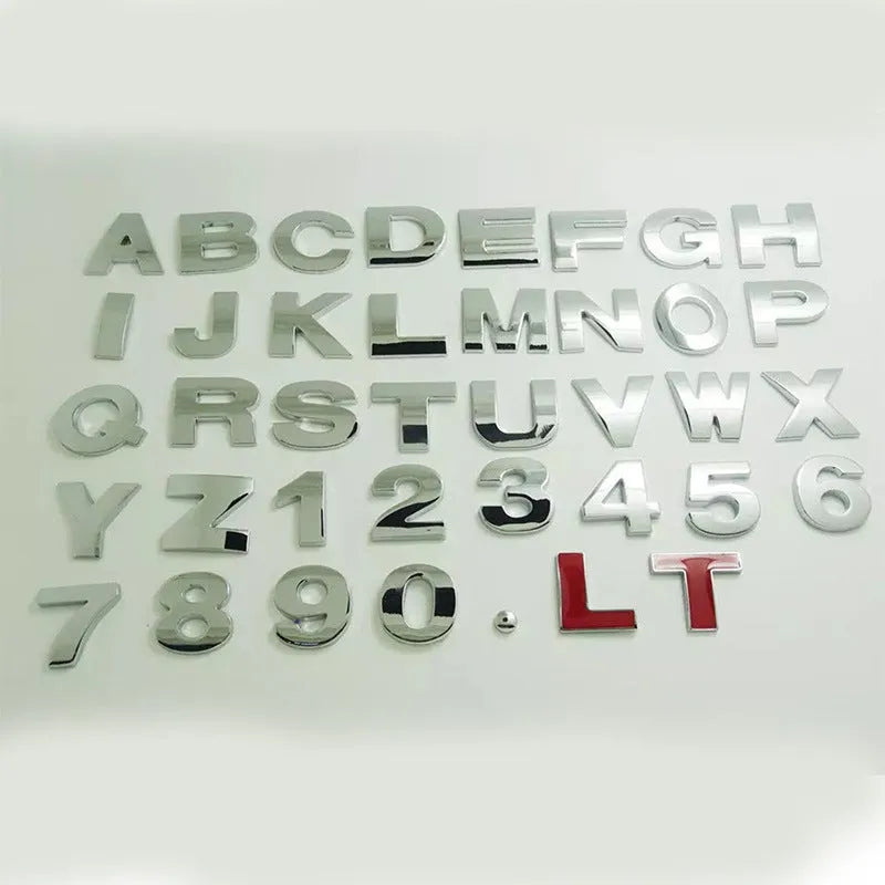 3D metal zinc alloy car letter sticker showing raised silver letter on clear adhesive backing.