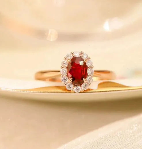 Gold pigeon and floral design sterling silver ring with a red blood gemstone inlay.