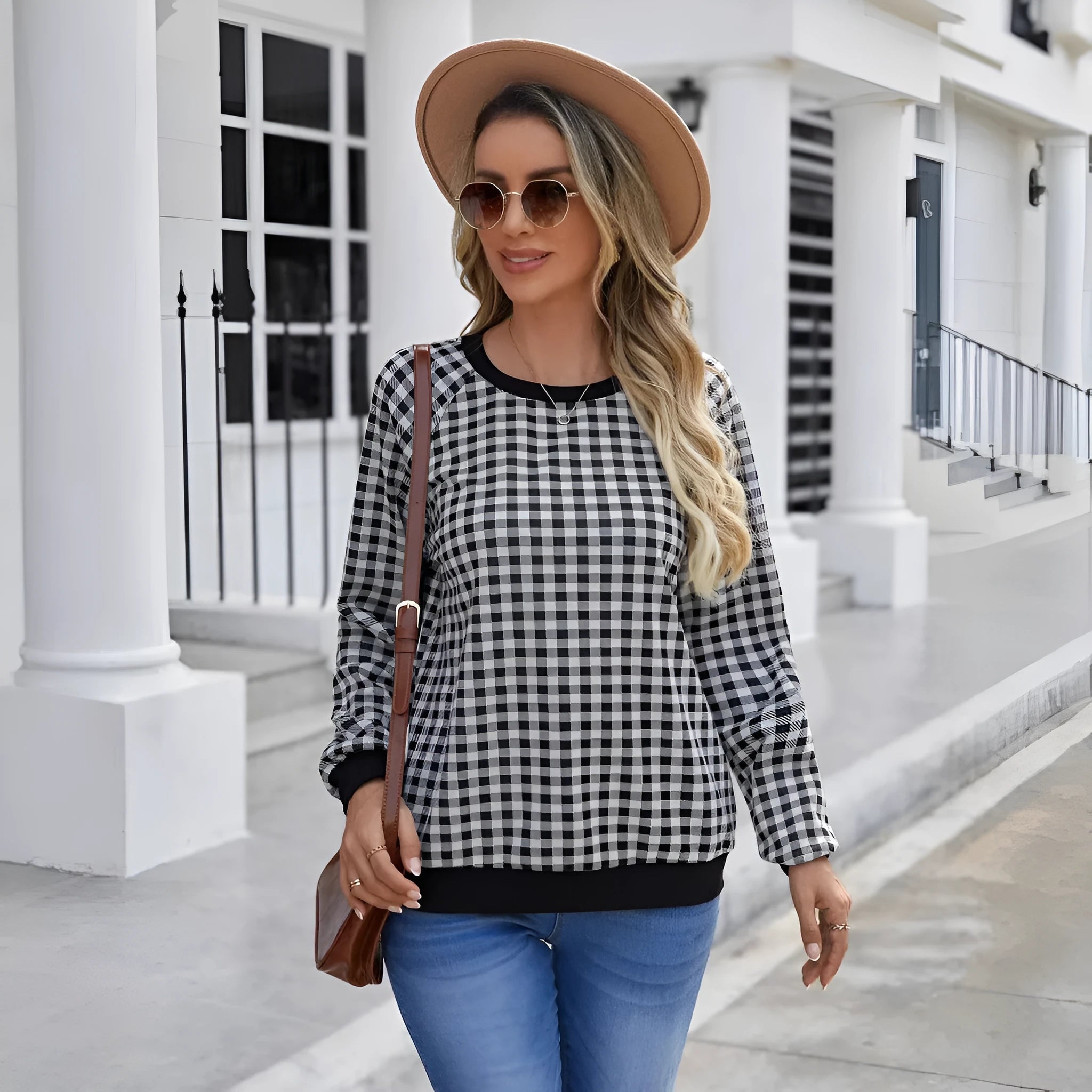 Black long sleeve pullover sweater with printed plaid and stripe pattern.
