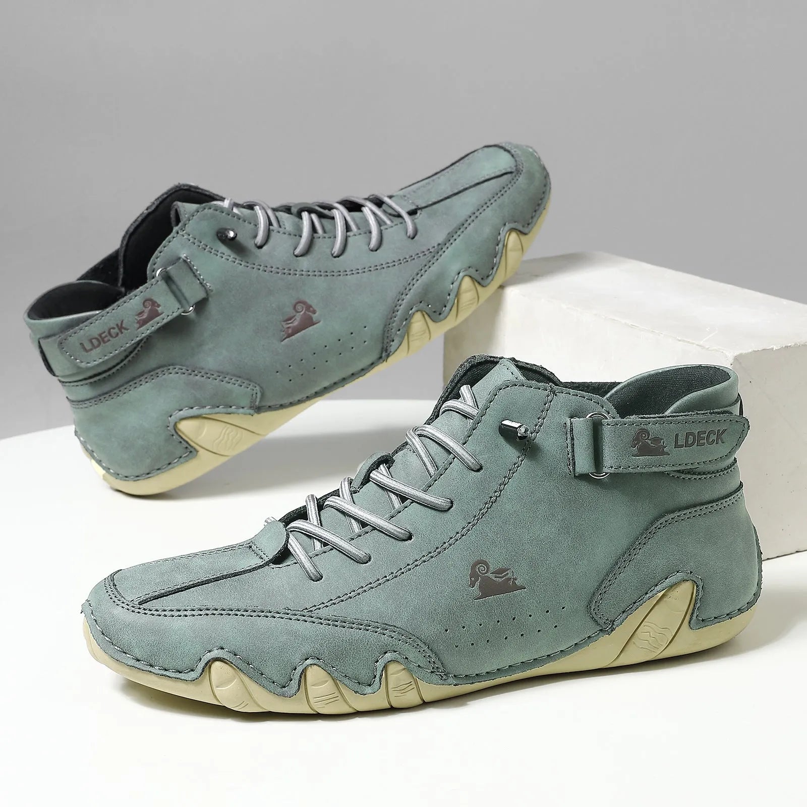 Men's khaki Octopus high top boots with microfiber upper, rubber sole, and pigskin boot tube on a white background.